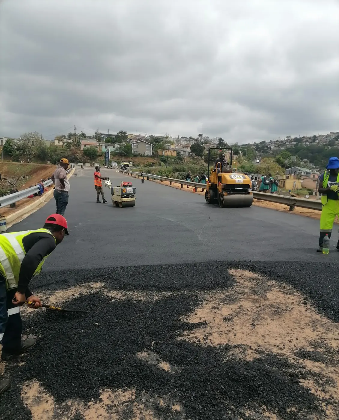 Ngubane crew rolling a fresh asphalt road surface