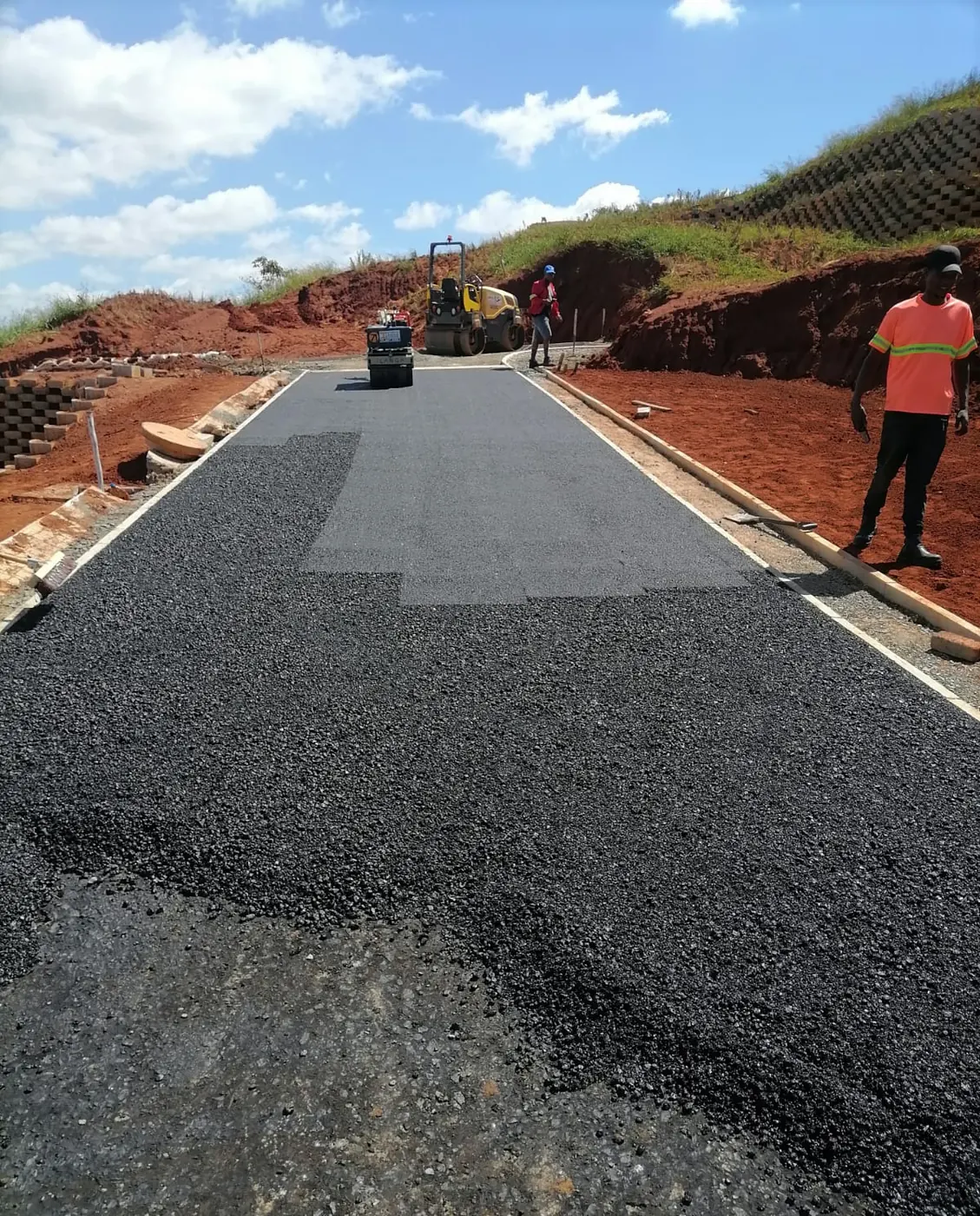Crew laying asphalt on a hillside road for Ngubane Contractors