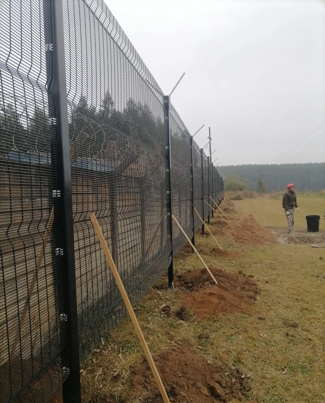 Ngubane crew member checking a new fence line on site