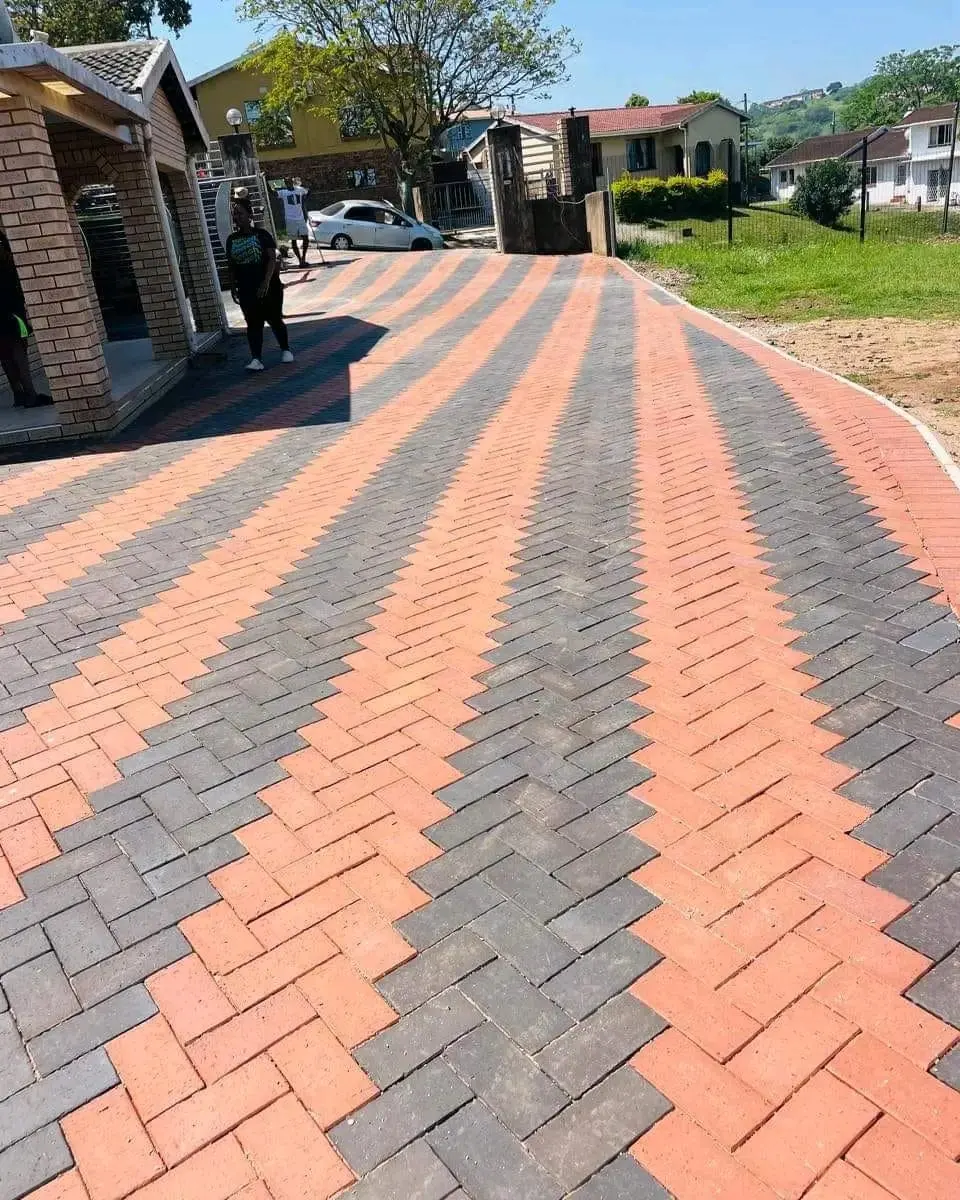 Herringbone paved driveway in charcoal and red pavers by Ngubane Contractors